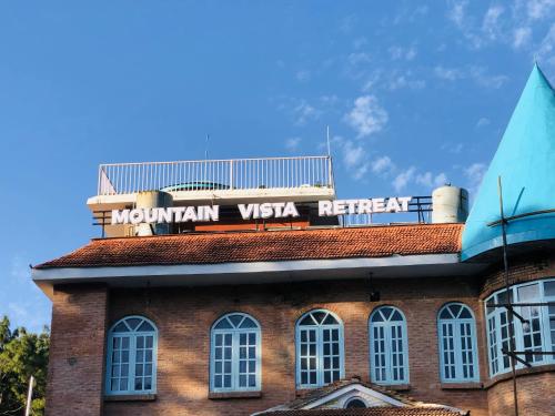 a brick building with a sign on top of it at Mountain Vista Retreat in Nagarkot
