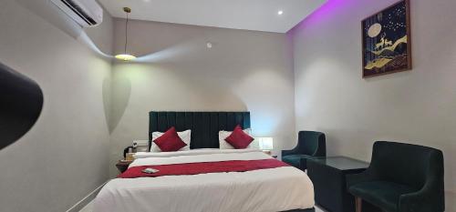 a hotel room with a bed and two chairs at Hotel K9 Regency sirsa in Sirsa