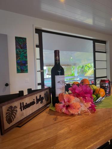 a bottle of wine sitting on top of a table at Heinani Lodge Tiahura in Moorea