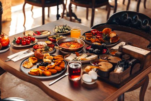 a table with many plates of food on it at Harem Suites Cappadocia in Uchisar