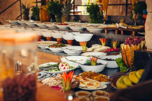 a buffet with many plates of food on a table at Harem Suites Cappadocia in Uchisar