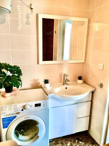 a bathroom with a washing machine and a sink at Дом в Боровом in Borovoye