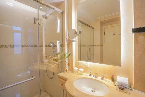 a bathroom with a sink and a shower at Broadway Mansions Hotel - On the Bund - Journey Through Time Old Shanghai Republic Dreams in Shanghai
