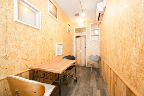 a room with a wooden table and chairs at Kotori Coworking & Hostel Kotohira in Kotohira