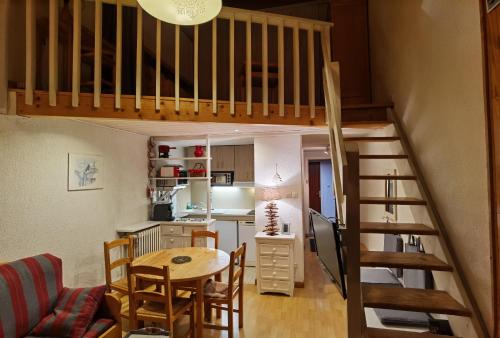 a living room and kitchen with a loft bed at MyHome - Génépis 29 - 4pax skis aux pieds Val Claret in Tignes