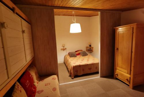 a bedroom with a bed in a room with a window at MyHome - Génépis 29 - 4pax skis aux pieds Val Claret in Tignes