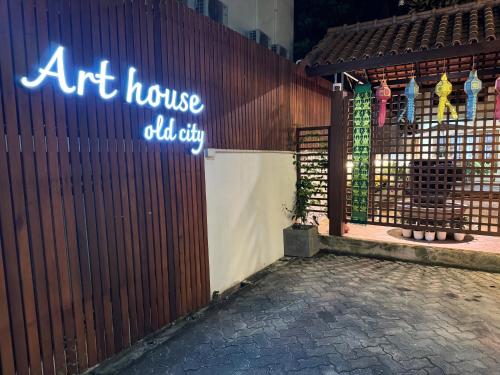 an art house old city sign on a fence at Art house Old City in Chiang Mai