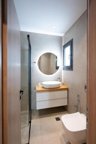a bathroom with a sink and a mirror at Novaio City Apartments in Ioannina