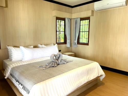 a bedroom with a bed with a towel on it at Kai Bae Beach Resort Koh Chang in Ko Chang