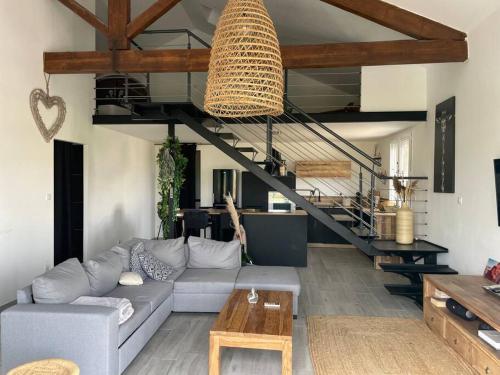 un salon avec un canapé et un escalier dans l'établissement Saint Gilles loft au pied du canal, à Saint-Gilles