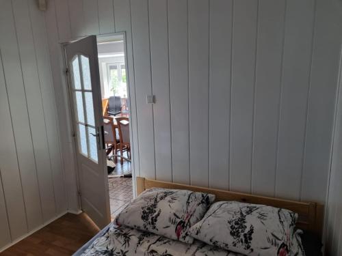 a bedroom with a bed and a mirror and a door at Willa Ostrzyce in Ostrzyce