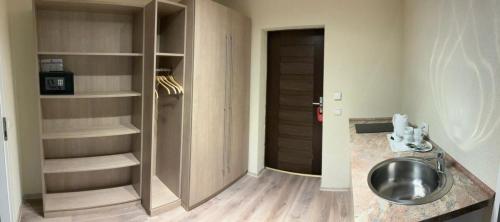 a bathroom with a sink and a closet at Landhotel Traube in Baden-Baden