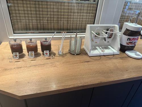 a wooden counter with a mixer and drinks on it at Hotel Empfinger Hof, Sure Hotel Collection by Best Western in Empfingen