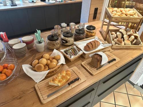 a table with various types of bread and pastries on it at Hotel Empfinger Hof, Sure Hotel Collection by Best Western in Empfingen