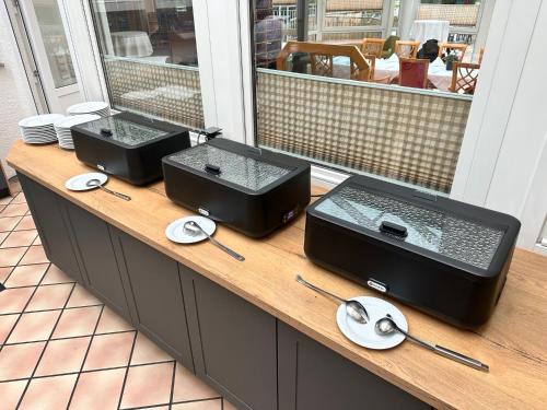 a counter with two food trays on a table at Hotel Empfinger Hof, Sure Hotel Collection by Best Western in Empfingen