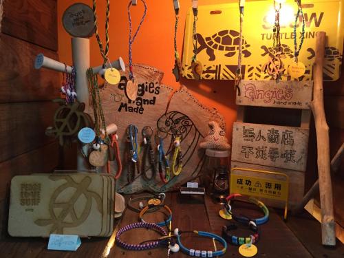 a room with a bunch of items on a table at Donghe surf shop & Hostel in Donghe