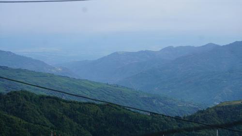 a view of a mountain valley with a train at Tranquil Retreat Homestay in Ghum