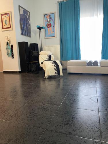 a living room with a tiled floor and a couch at Thiseos Georgia's Private Paradise in Lékhaion