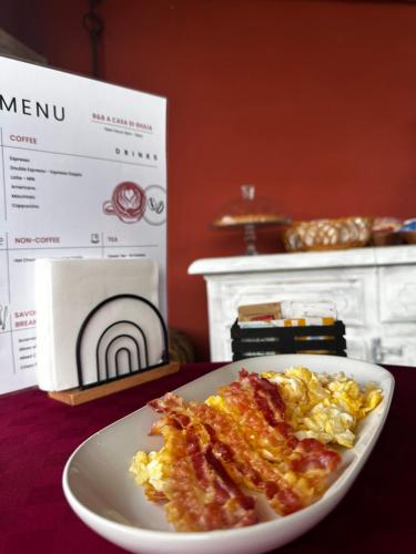 a plate of breakfast food on a table with a box at B&B A casa di Giulia in Guidonia