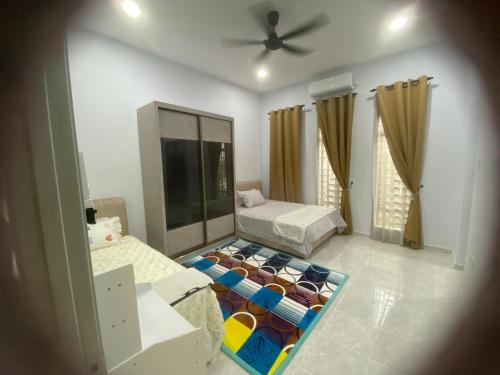 a living room with a bed and a couch at Homestay Mak Arah 2 MU5L1M shj in Kemaman