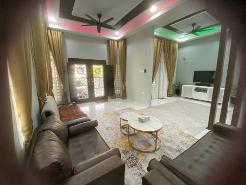 a living room with a couch and a table at Homestay Mak Arah 2 MU5L1M shj in Kemaman