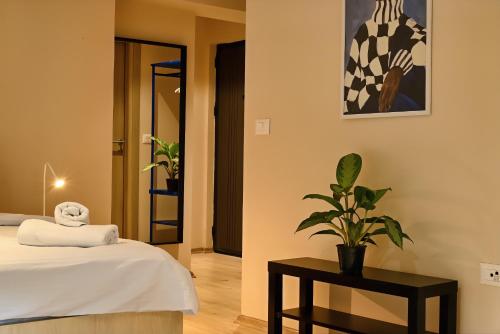 a bedroom with a bed and a plant on a table at Central Studio Apartments by Parkside Boutique in Skopje