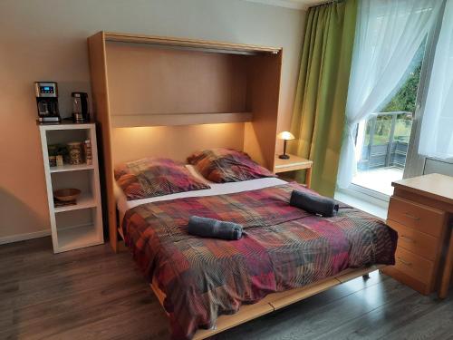 a bedroom with a large bed and a window at Family Appartment in Sankt Englmar