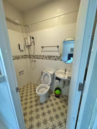 a small bathroom with a toilet and a sink at Van Vliet Hostel in Phra Nakhon Si Ayutthaya