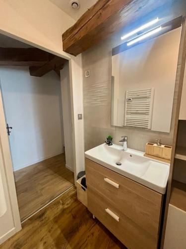 une salle de bain avec un lavabo et un miroir dans l'établissement Charmante maison mitoyenne 8 couchages, à Touillon-et-Loutelet
