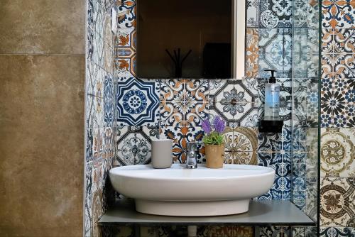 a bathroom with a sink and a mirror at Central Studio Apartments by Parkside Boutique in Skopje
