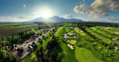 an aerial view of a golf course with mountains in the background at Vila Valentina in Veľká Lomnica