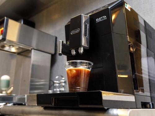 a coffee maker is making a drink on a counter at Inuyama Miyako Hotel in Inuyama