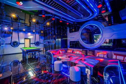 a party room with red couches and a table at T M L-Manor House 6 bedroom-independent swimming pool and powerful KTV in Ban Huai Yai
