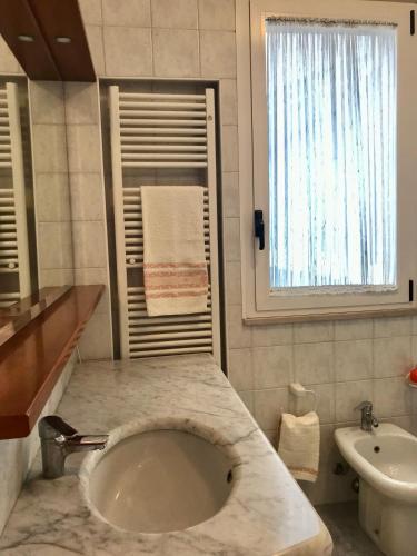 a bathroom with a sink and a toilet at Appartamento per relax in Rimini