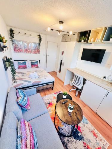 a living room with a couch and a table at Newly Renovated Private and Modern Shared Apartment, Each with Kitchenette, Central Birmingham RB in Birmingham