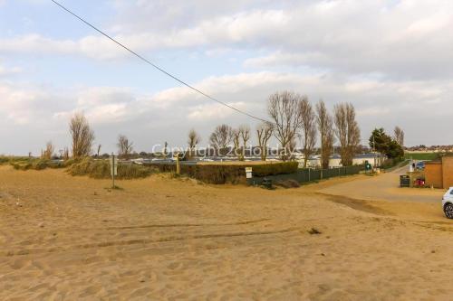 a dirt road with a car parked on it at Wonderful 6 Berth Caravan In Norfolk At Heacham Beach, Ref 21012E in Heacham