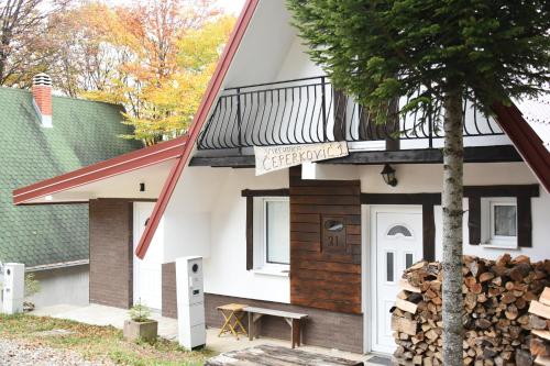 a house with a deck on the side of it at Vikendica Čeperković #1 in Kopaonik