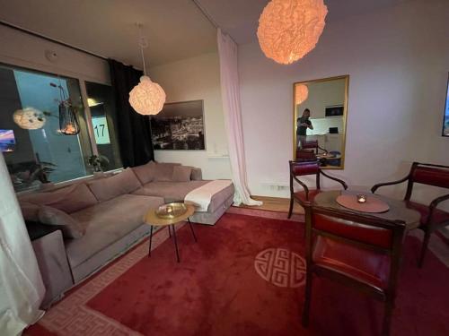 a living room with a couch and a table at 50m2 i Stockholm - Täby in Stockholm