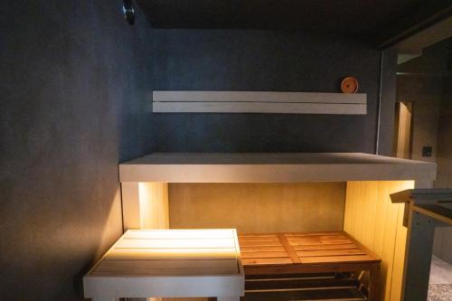 a small room with a wooden shelf with at SAUNALAND ASAKUSA in Tokyo
