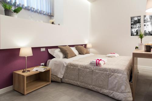 a bedroom with a large bed and a table at l'angolo di Frima in Matera