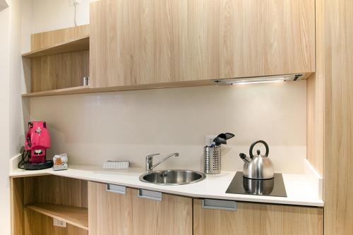 a kitchen counter with a sink and a tea kettle at l'angolo di Frima in Matera