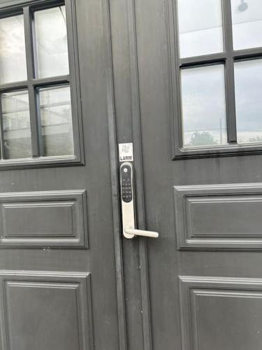 a metal door with a remote control on it at Privat och lyxig in Landvetter