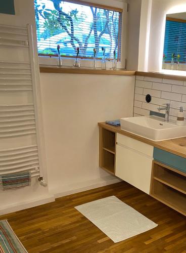 a bathroom with a sink and a window at AirB33 Apartment Munich privat with little terrace in Munich