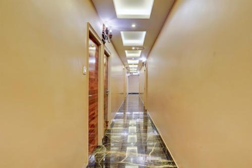 a long hallway with a tile floor and ceiling at Super Townhouse NK Vivanta Luxury Rooms in Chennai