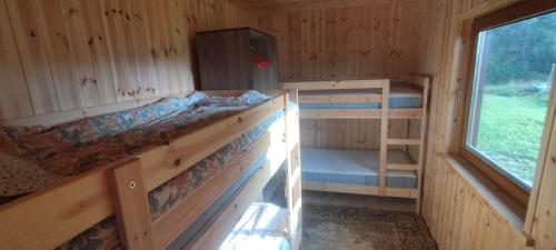 a room with two bunk beds and a window at Rapla Ratsakeskuse puhkemaja, Rapla Equestrian Centre holidayhouse in Libadu