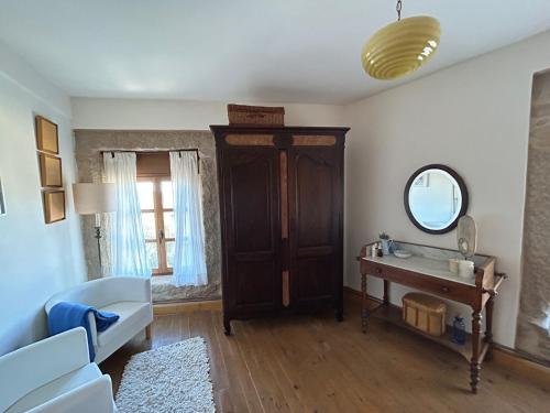 a living room with a table and a mirror at GEODA Fornillos -Refugio en los Arribes del Duero in Fornillos de Fermoselle