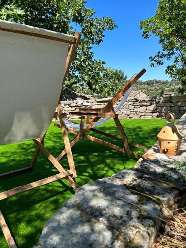 a picnic table and a chair in a yard at GEODA Fornillos -Refugio en los Arribes del Duero in Fornillos de Fermoselle