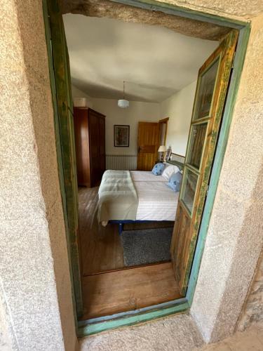 a view of a bedroom through a doorway at GEODA Fornillos -Refugio en los Arribes del Duero in Fornillos de Fermoselle