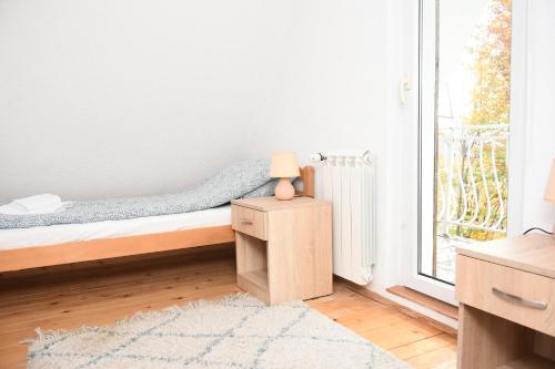 a small bedroom with a bed and a window at Vikendica Čeperković #1 in Kopaonik