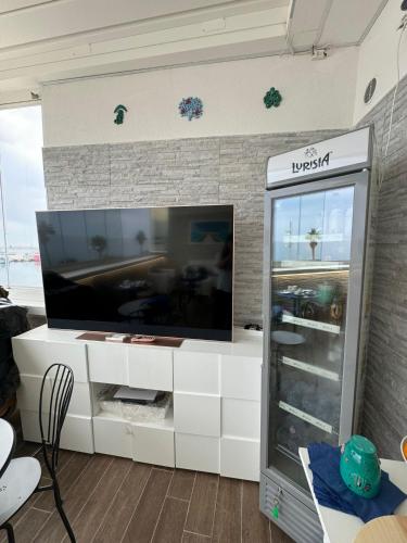 a living room with a large flat screen tv at Vista Mare in Mola di Bari